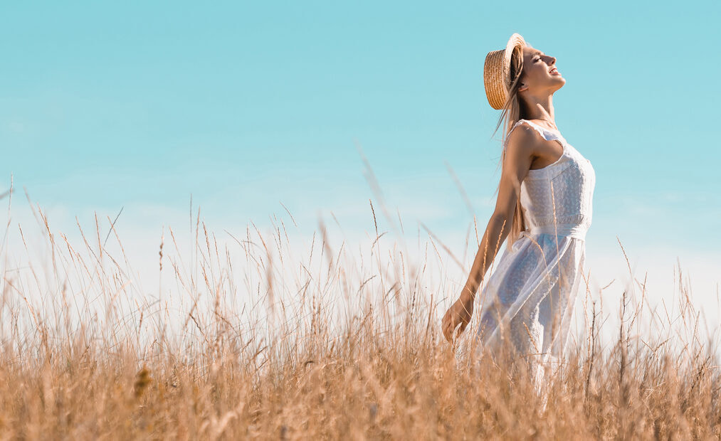 Woman in wheat field, feeling the freedom that being real can bring
