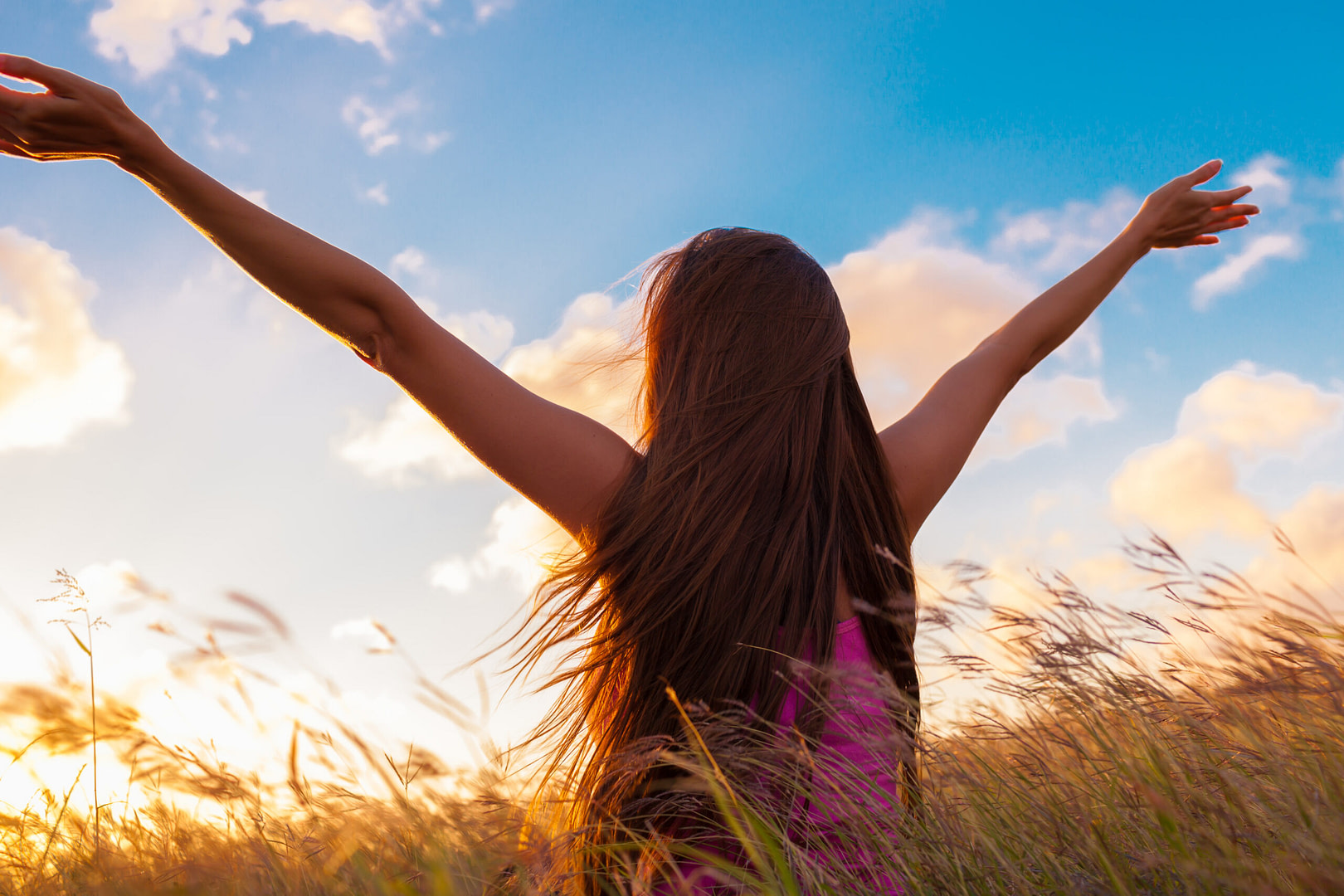 Woman with arms to the sky portraying the message of living for yourself