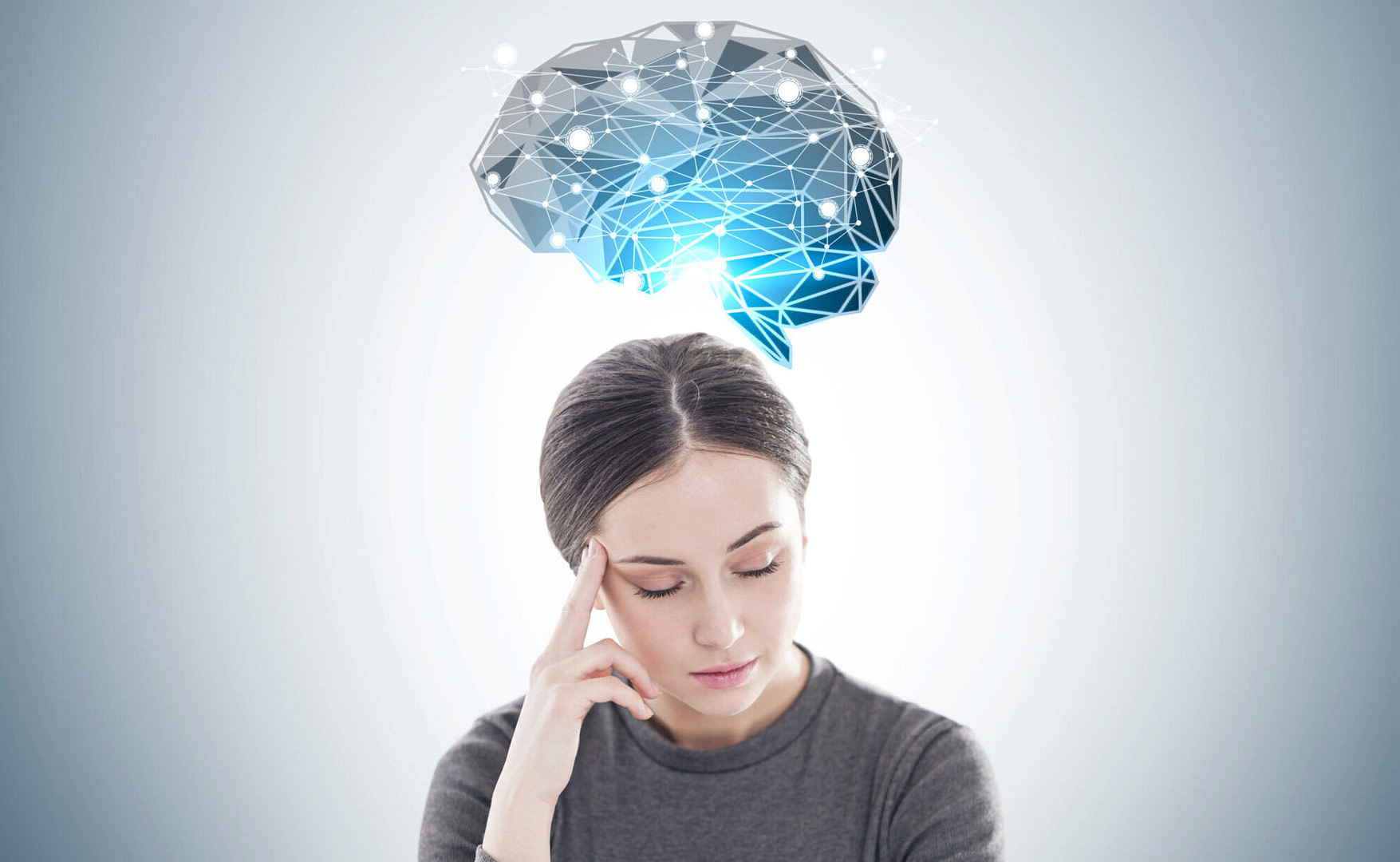 Woman thinking with a glowing brain sketch above her head portraying the power of thoughts