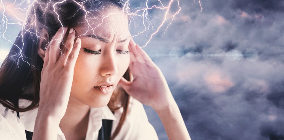 Woman getting worried holding her head against cloudy sky Woman getting worried holding her head against cloudy sky