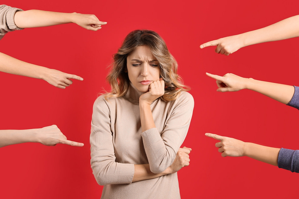 Stressed woman with arms pointed at her finding it hard to live for herself Stressed woman with arms pointed at her finding it hard to live for herself