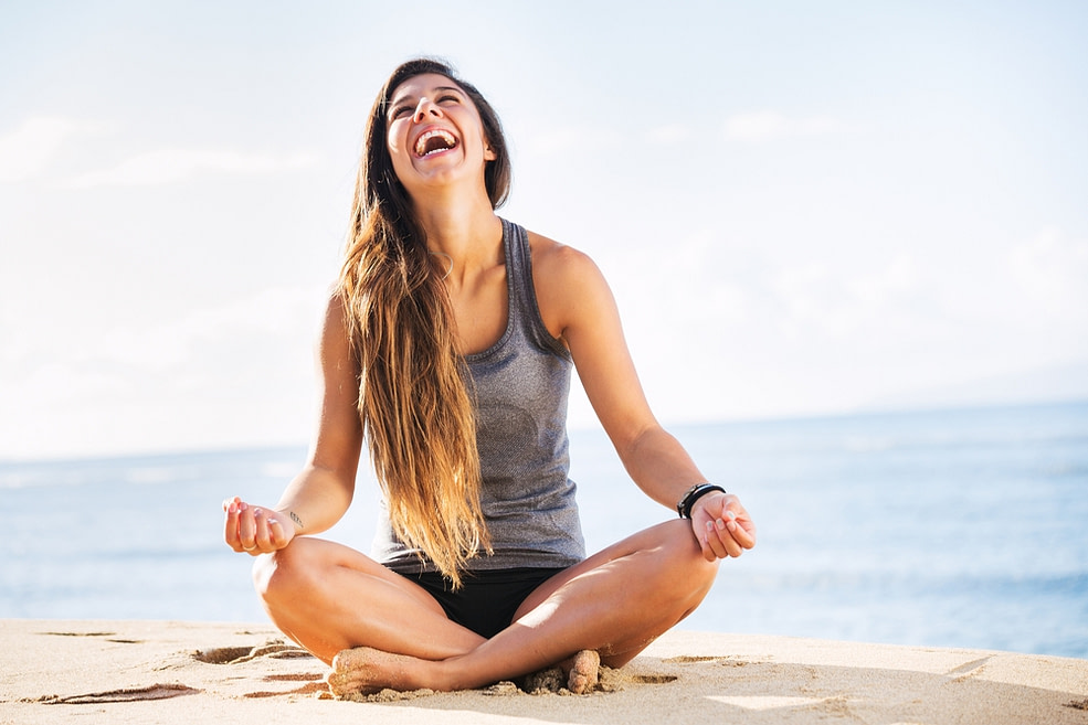 Woman sitting on beach experiencing the feeling of living her truth Woman sitting on beach experiencing the feeling of living her truth