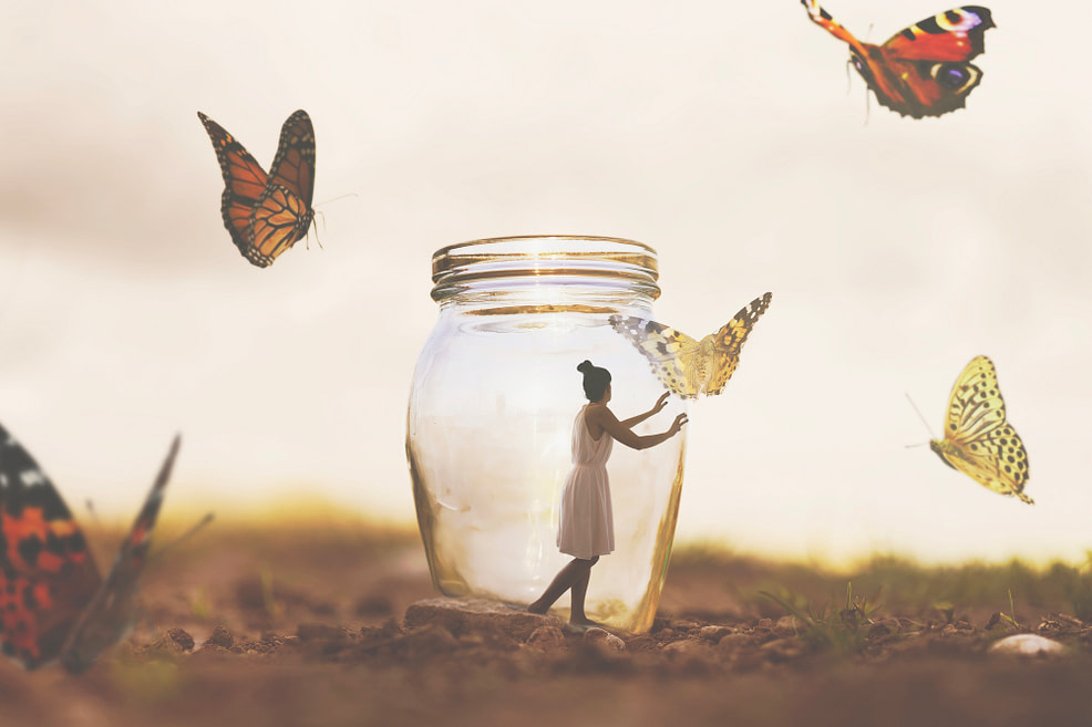 surreal woman is prisoner in a glass vase with butterflies flying around, abstract concept woman is prisoner in a glass vase with butterflies flying around
