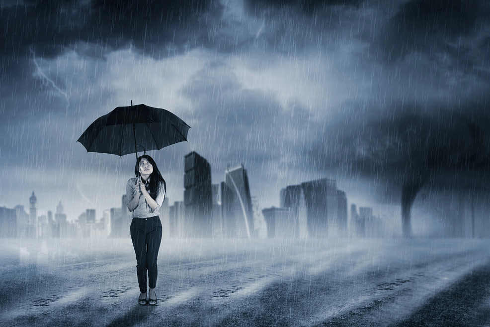 Woman with umbrella standing in a storm Woman with umbrella standing in a storm