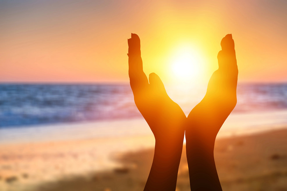 hands cupping a sunset over the ocean-exercising gratitude hands cupping a sunset over the ocean-exercising gratitude