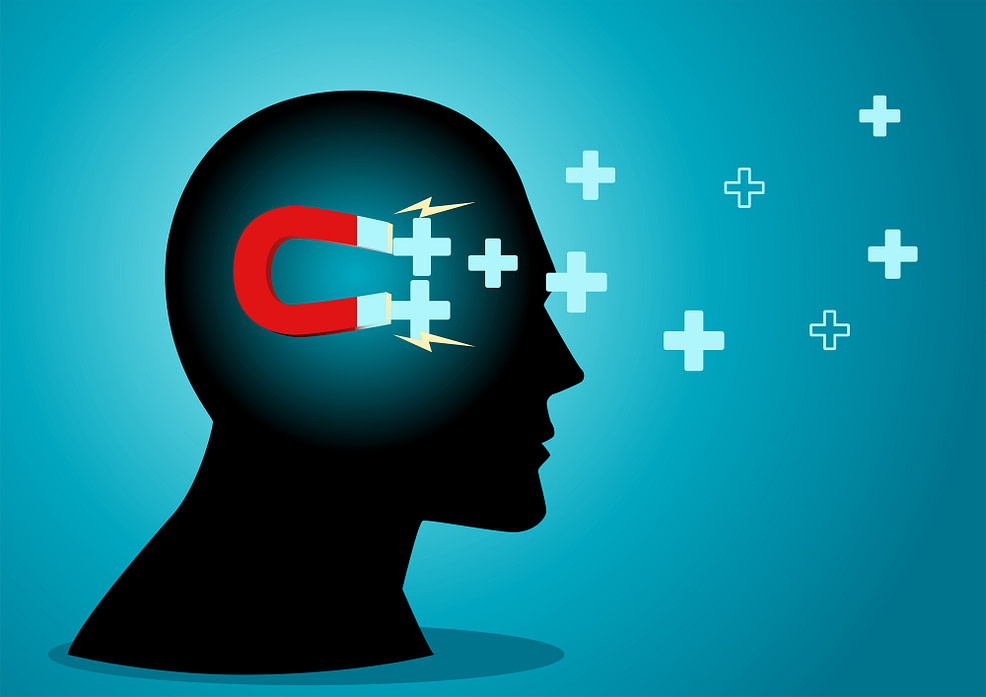 Human head with magnet inside attracting positive symbols Vector illustration of human head with magnet inside attracting positive symbols. Positive mind concept