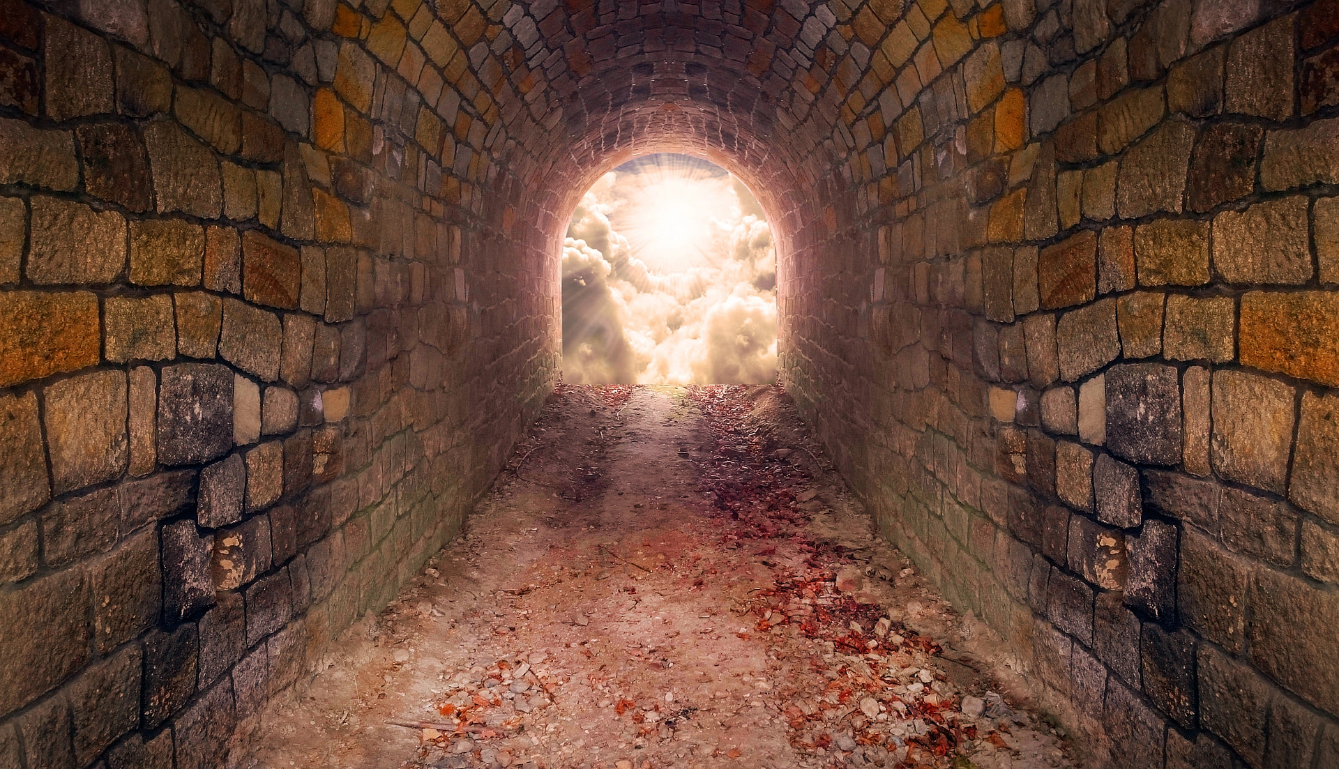 Light with clouds at the end of a tunnel, representing climbing to freedom