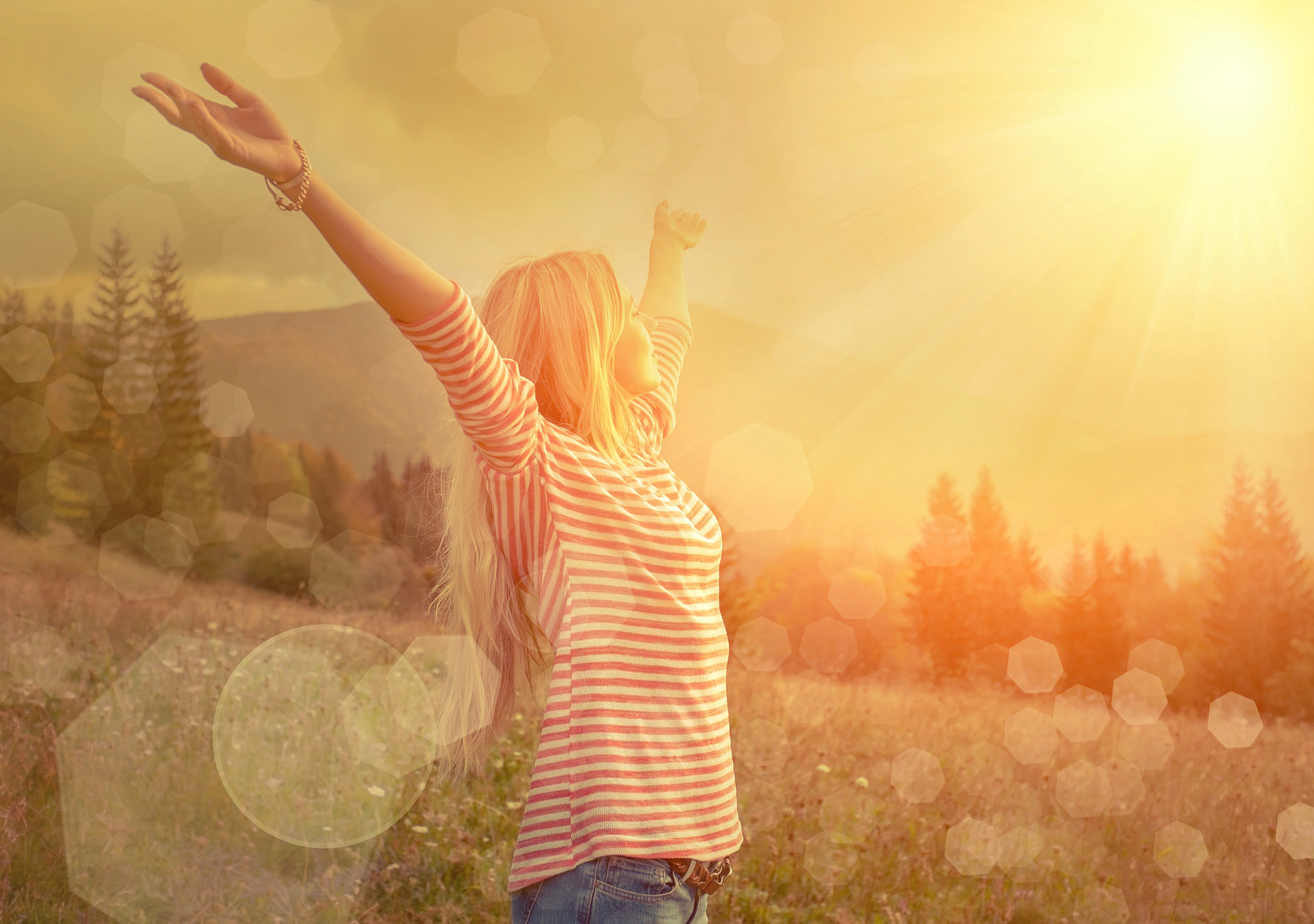 Woman standing outside in the sun with armed outstretched to the sky. Concept of embracing the path forward